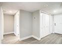 White hallway with light grey floors and multiple doors at 400 Island Way # 1411, Clearwater Beach, FL 33767