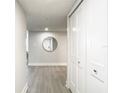 Hallway with white doors and a circular mirror at 400 Island Way # 1411, Clearwater Beach, FL 33767