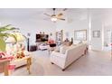 Cozy living room with a ceiling fan, comfortable seating, and an entertainment center at 5201 Pless Rd, Plant City, FL 33565