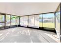 Bright, enclosed sunroom with large windows overlooking the backyard at 5201 Pless Rd, Plant City, FL 33565