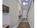 Bright and spacious entrance hall with hardwood floors and staircase at 6337 Waves End Pl, Apollo Beach, FL 33572