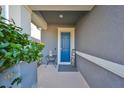 Inviting front entry with a blue door, small table, and 'Home' sign at 6337 Waves End Pl, Apollo Beach, FL 33572