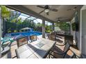 Relaxing screened-in pool area with patio furniture and dining table at 6337 Waves End Pl, Apollo Beach, FL 33572