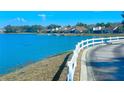 Serene lake view with waterfront homes featuring private docks and calm blue water, enhancing the tranquil neighborhood at 9107 Lingrove Rd, Weeki Wachee, FL 34613