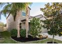 Two-story house with palm trees and manicured landscaping at 11418 Sage Canyon Dr, Riverview, FL 33578