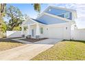 Two-story light blue house with white trim, a white garage door, and a covered porch at 3005 E 17Th Ave, Tampa, FL 33605