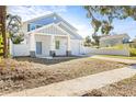 Two-story light blue house with white trim, a white garage door, and a covered porch at 3005 E 17Th Ave, Tampa, FL 33605