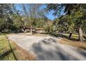Long driveway leading to a single-story home with mature trees at 4609 Horton Rd, Plant City, FL 33567