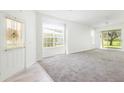 Bright, airy living room with plush carpeting and sliding glass doors leading to the outdoor space at 5733 Heronpark Pl, Lithia, FL 33547