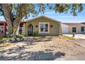 Charming one-story home with a green exterior and landscaping at 7505 Eastmoor Ct, Tampa, FL 33615