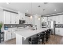 Spacious kitchen featuring white cabinets, quartz countertops, and stainless steel appliances at 10507 Daybreak Gln, Parrish, FL 34219