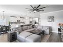 Open living space with large sectional sofa, coffee table, and access to backyard at 10507 Daybreak Gln, Parrish, FL 34219