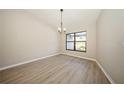 Light-filled dining area with laminate floors and a chandelier at 15909 Amberly Dr, Tampa, FL 33647