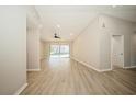 Bright and airy living room with laminate floors and sliding glass doors at 15909 Amberly Dr, Tampa, FL 33647