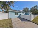 Side view of charming light blue house with driveway at 1846 3Rd S St, St Petersburg, FL 33705