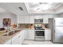Modern kitchen with granite countertops and stainless steel appliances at 460 Paula S Dr # 101, Dunedin, FL 34698
