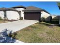 House exterior featuring a driveway and front yard at 5358 Blue Horizon Way, Wimauma, FL 33598