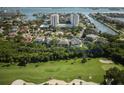 Aerial view of the house outlined in blue, showcasing its waterfront location and golf course proximity at 5951 Bay Dr, Gulfport, FL 33707