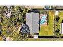 Aerial view of the house featuring a pool in a screened enclosure and a well maintained yard at 7801 17Th N Way, St Petersburg, FL 33702