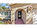 Inviting entryway with arched entry and brick walkway at 7801 17Th N Way, St Petersburg, FL 33702