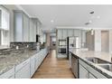 Spacious kitchen with gray cabinets and granite countertops at 1192 Multiflora Loop, Lutz, FL 33558