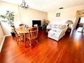 Living room with a dining area, hardwood floors, and ample natural light at 1235 S Highland Ave # 2-308, Clearwater, FL 33756