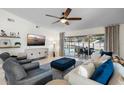 Bright living room with comfortable seating, large TV, and view of the pool at 22 Turnstone Dr, Safety Harbor, FL 34695