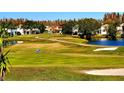 Landscaped golf course with a pond and residential homes at 4027 Harbor Lake Dr, Lutz, FL 33558