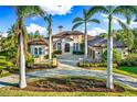 Luxury home with lake view, beautifully landscaped grounds, and a three-car garage at 8376 Catamaran Cir, Lakewood Ranch, FL 34202