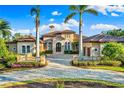 Mediterranean style home with three-car garage and meticulously landscaped grounds at 8376 Catamaran Cir, Lakewood Ranch, FL 34202