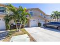 Two-story townhome with attached garage and landscaping at 9047 Antigua Dr, Seminole, FL 33777