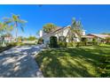 House exterior showcasing a driveway, garage, and well-maintained landscaping at 11114 Lake Sassa Dr, Thonotosassa, FL 33592