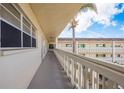 Outdoor hallway with white railings and building access at 2451 Canadian Way # 47, Clearwater, FL 33763