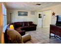 Cozy living room with leather sectional sofa, recliner, and classic wooden furniture at 3649 Bradford Dr, Holiday, FL 34691