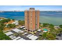 Aerial view of a high-rise building with parking and pool, overlooking the bay at 4015 Bayshore Blvd # 16A, Tampa, FL 33611