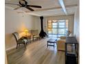 This beautiful living room features a unique fireplace, ceiling fan and sliding glass doors at 4500 37Th S St # 27, St Petersburg, FL 33711