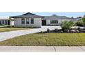 Contemporary home with new landscaping and paver driveway at 475 Island Way, Clearwater Beach, FL 33767