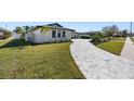Modern home with a paver walkway and lush landscaping at 475 Island Way, Clearwater Beach, FL 33767
