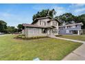 Two-story house with a gray exterior, landscaping, and walkway at 701 N Warnell St, Plant City, FL 33563