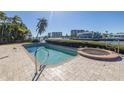 Inviting pool and spa area with brick pavers at 15 Marina Ter, Treasure Island, FL 33706