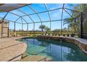 Relaxing pool area with screened enclosure and water features at 15435 27Th E Ct, Parrish, FL 34219