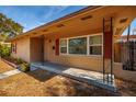 Front view of a tan brick ranch home with red shutters at 2621 13Th N St, St Petersburg, FL 33704