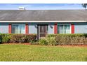 Blue home with red shutters, screen door, and manicured hedges at 3111 Lewis Rd, Dover, FL 33527