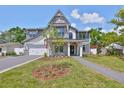 Charming two-story home with a manicured lawn, stone accents, and a welcoming front entrance at 3509 W Leona St, Tampa, FL 33629