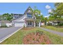 Beautiful two-story home with a stone facade, a well-kept lawn, and a classic American flag at 3509 W Leona St, Tampa, FL 33629