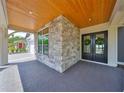 Inviting front entrance with stone detailing, double doors with wreaths, and wood ceiling at 3509 W Leona St, Tampa, FL 33629