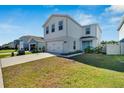 Two-story house with a two-car garage and a landscaped front yard at 3779 Zephyr Preserve Pl, Zephyrhills, FL 33541