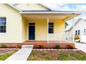 Charming front porch with white railing and brick steps at 411 Whitehall St, Plant City, FL 33563