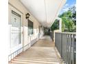 Inviting condo hallway with covered walkways, and well-maintained exterior at 820 Patricia Ave # 207, Dunedin, FL 34698