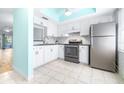 Modern kitchen featuring white cabinets, stainless steel appliances, and a light and airy feel at 820 Patricia Ave # 207, Dunedin, FL 34698